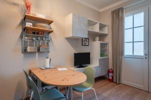 a dining room with a wooden table and chairs at La casina di Kino in Lucca