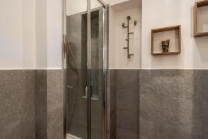 a shower with a glass door in a bathroom at La casina di Kino in Lucca +13 photos