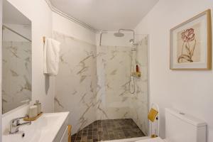 a white bathroom with a shower and a sink at Praia da Granja - Seaside Beach in Arcozelo +11 photos