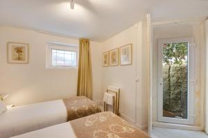 a bedroom with two beds and a window at Praia da Granja - Seaside Beach in Arcozelo