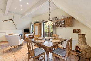 a dining room with a wooden table and chairs at Ferienwohnung Am Orpeturm in Marsberg