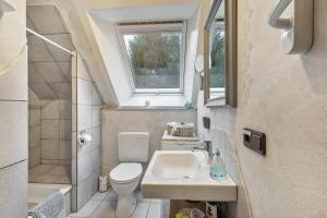 a small bathroom with a sink and a toilet at Ferienwohnung Am Orpeturm in Marsberg +14 photos