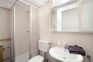 a bathroom with a toilet and a sink and a mirror at Pension Waldheim Rooms in San Giacomo +119 photos