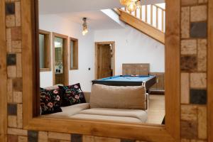 a living room with a couch and a pool table at Villa Peaky in Yaiza