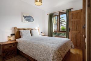 a bedroom with a bed and a window at Villa Peaky in Yaiza +22 photos