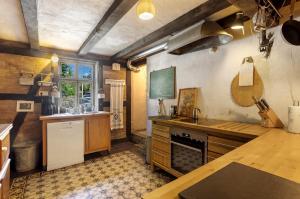 a kitchen with a counter and a sink and a stove at Haus Berlar in Bestwig