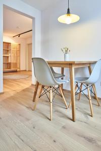 a dining room with a wooden table and two chairs at Alte Seifensiederei - Fabienne in Bad Tölz