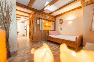 a bedroom with a bed and chairs in a room at Sonnleiten Sonnenparadies in Collepietra +28 photos