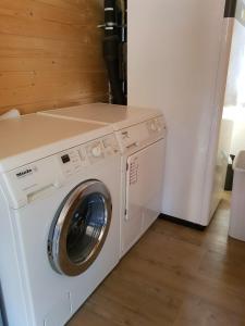 a white washer and dryer in a room at Ferienhaus Wolfshütte in Hillesheim