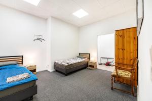 a bedroom with a bed and a chair in it at Menzel Ferienwohnungen - W3 in Beckingen