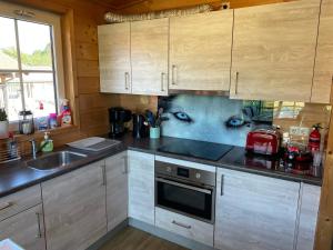 a kitchen with a painting of an eye on the wall at Ferienhaus Wolfshütte in Hillesheim