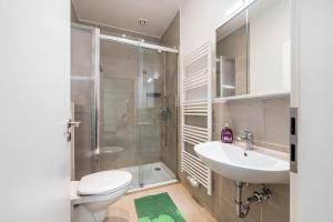 a bathroom with a toilet and a sink and a shower at Menzel Ferienwohnungen - W3 in Beckingen +20 photos