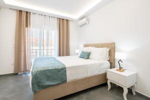 a bedroom with a large bed and a window at Velvet Apartments in Rhodes Town