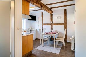 a kitchen and dining room with a table and chairs at Wohnung 2 in Wallhausen +11 photos