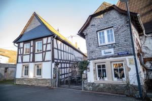 an old house with a black and white building at Wohnung 2 in Wallhausen