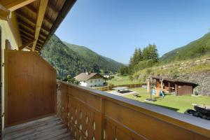 a balcony with a view of the mountains at Pension Waldheim Rooms in San Giacomo