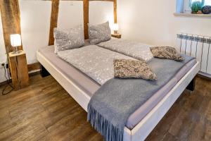a bed with two pillows on it in a room at Wohnung 2 in Wallhausen