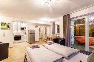 a bedroom with two beds and a kitchen with a table at Ferienwohnung Viadukt in Willingen