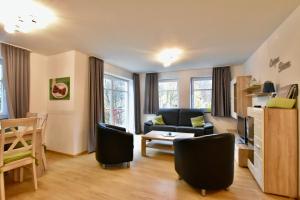 a living room with a couch and a table at Ferienwohnung Viadukt in Willingen
