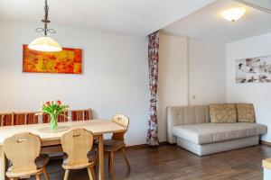 a living room with a dining room table and a couch at Alpenflora 1 in Ischgl
