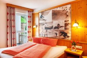 a bedroom with a bed and a large picture on the wall at Alpenflora 1 in Ischgl