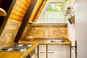 a small kitchen with a sink and a window at Villa Königsdorf am See in Waldkirchen +13 photos