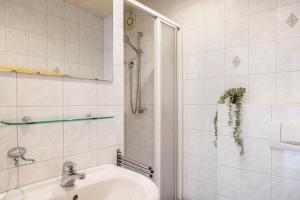 a white bathroom with a sink and a shower at Pension Stilletal - Springstille in Springstille +16 photos
