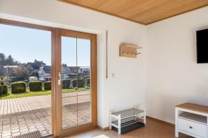 a room with a sliding glass door with a balcony at Pension Stilletal - Springstille in Springstille