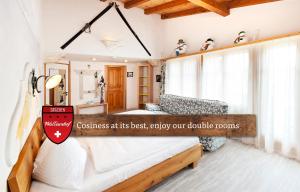 A bed or beds in a room at Hotel Walliserhof - The Dom Collection