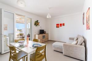 a living room with a table and a couch at Donasand_torre san giovanni in Torre San Giovanni Ugento