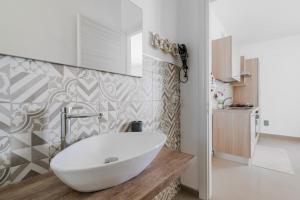 a bathroom with a white bowl sink on a counter at Donasand_torre san giovanni in Torre San Giovanni Ugento +19 photos