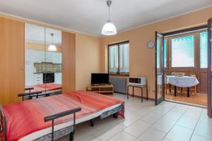 a bedroom with a bed and a living room at Casa D'Agostino in Aosta