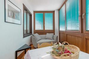 a living room with a table and a chair at Casa D'Agostino in Aosta