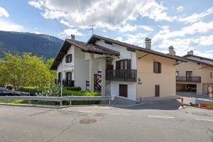 a white house with a fence in front of it at Casa D'Agostino in Aosta
