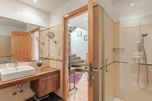 a bathroom with a sink and a shower at Villa Almeda in Port d'Andratx +18 photos