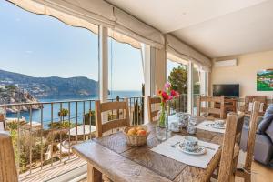 a dining room with a table with a view of the ocean at Villa Almeda in Port d'Andratx