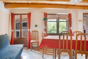 a dining room with a red table and chairs at Carlina Tano di Grich in Cesani