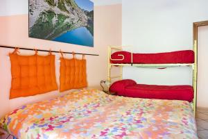 a bedroom with a bed and two bunk beds at Carlina Tano di Grich in Cesani