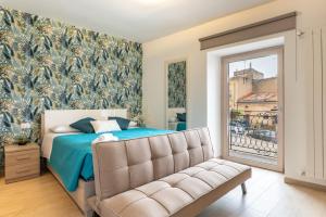 a bedroom with a bed and a couch at Vico degli Orti in Mistretta