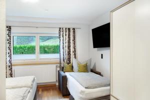 a bedroom with a bed and a mirror and a window at Apart Löffler in Kappl