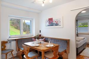a dining room with a table and chairs and a bed at Apart Löffler in Kappl