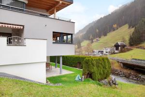 a house on a hill with a view of a river at Apart Löffler in Kappl