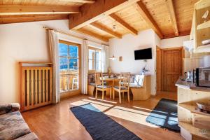 a living room with a table and a dining room at Apartments Campagnola in Badia