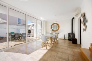 a living room with a table and a dining room at Lagos Beach Pool Villa in Lagos