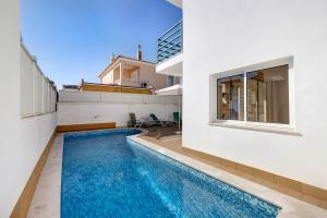 a swimming pool in the middle of a house at Lagos Beach Pool Villa in Lagos