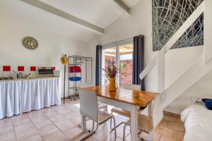 a kitchen and dining room with a table and chairs at Mas des Cypres - Mazet 5 in Saintes-Maries-de-la-Mer +17 photos