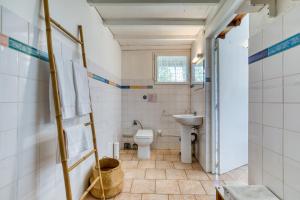 a bathroom with a toilet and a sink at Mas des Cypres - Mazet 5 in Saintes-Maries-de-la-Mer