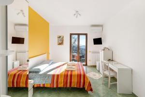 a bedroom with a bed and a desk in it at Coast 2 Coast in Agerola