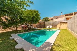 a swimming pool in the yard of a house at Villa Ca Na Campins in Campanet