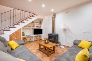 a living room with a couch and a wood stove at Villa Ca Na Campins in Campanet